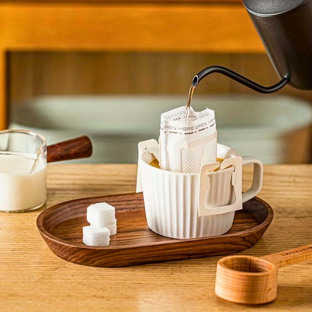 Drip coffee setup with sugar cubes and ribbed mug on walnut Mokura oval tray in cozy kitchen