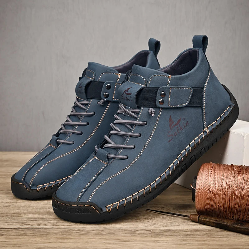 A pair of Brown leather ankle sneakers with slip-on elastic collar and detailed stitching