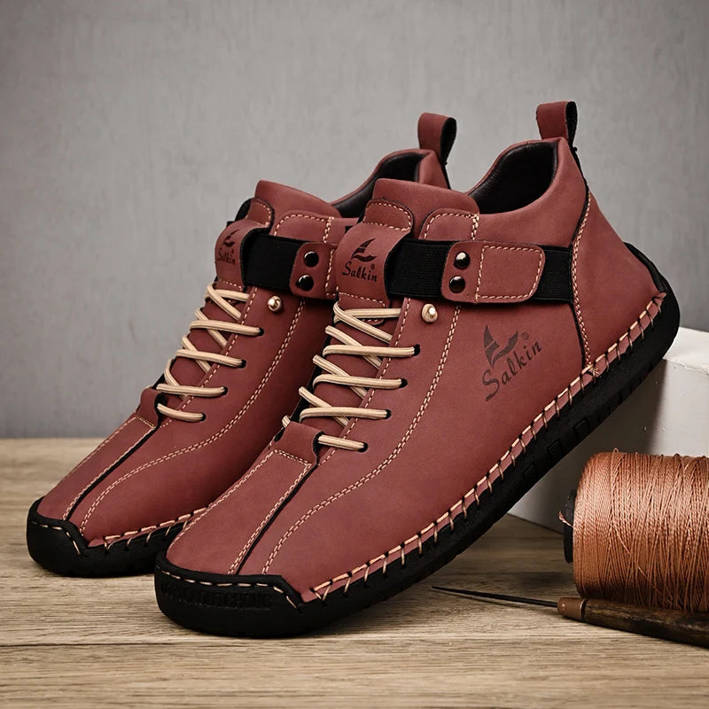 A pair of Red-brown men's sneakers with stitched leather upper and pull-on design