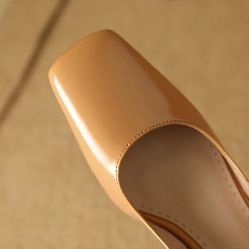 Apricot patent leather pumps, top view showing sole texture