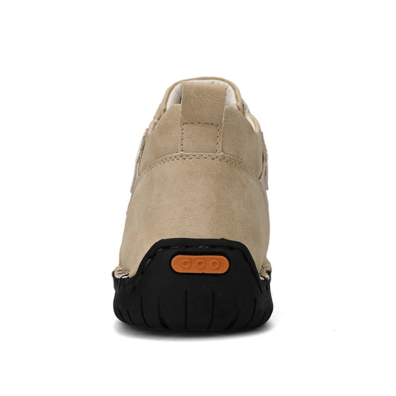 Back view of beige handmade sneaker showing heel tab and easy-on construction