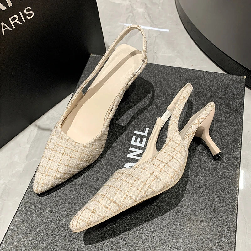 Beige tweed slingback heels with adjustable strap and slim heel on display