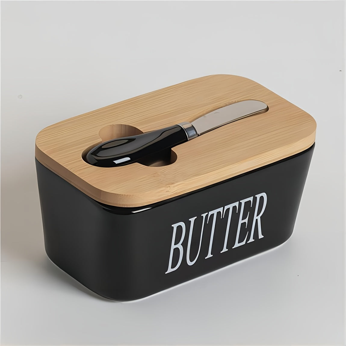 Black ceramic butter dish with bamboo lid and stainless steel spreader