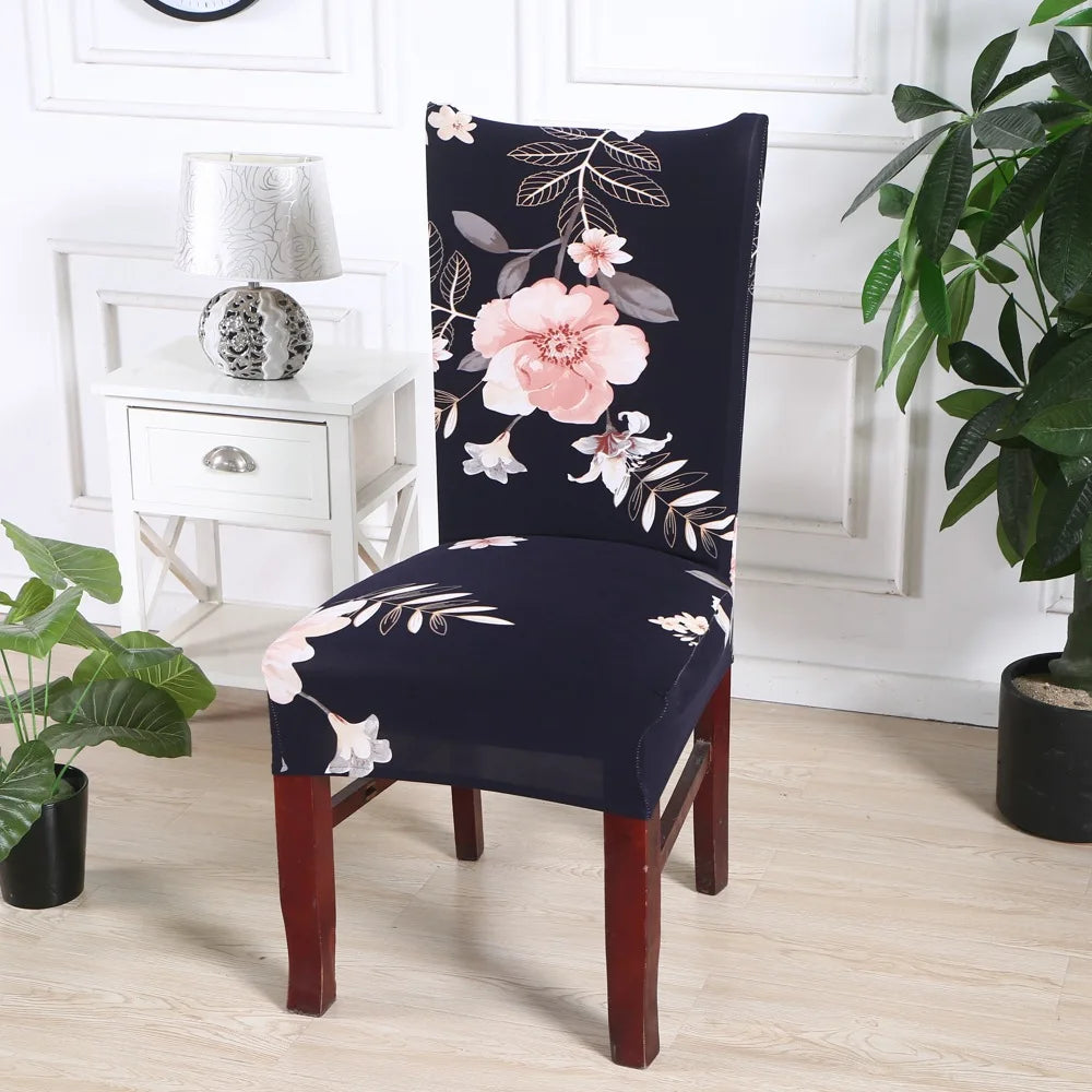 Black chair slipcover with soft pink floral and botanical design in white modern interior