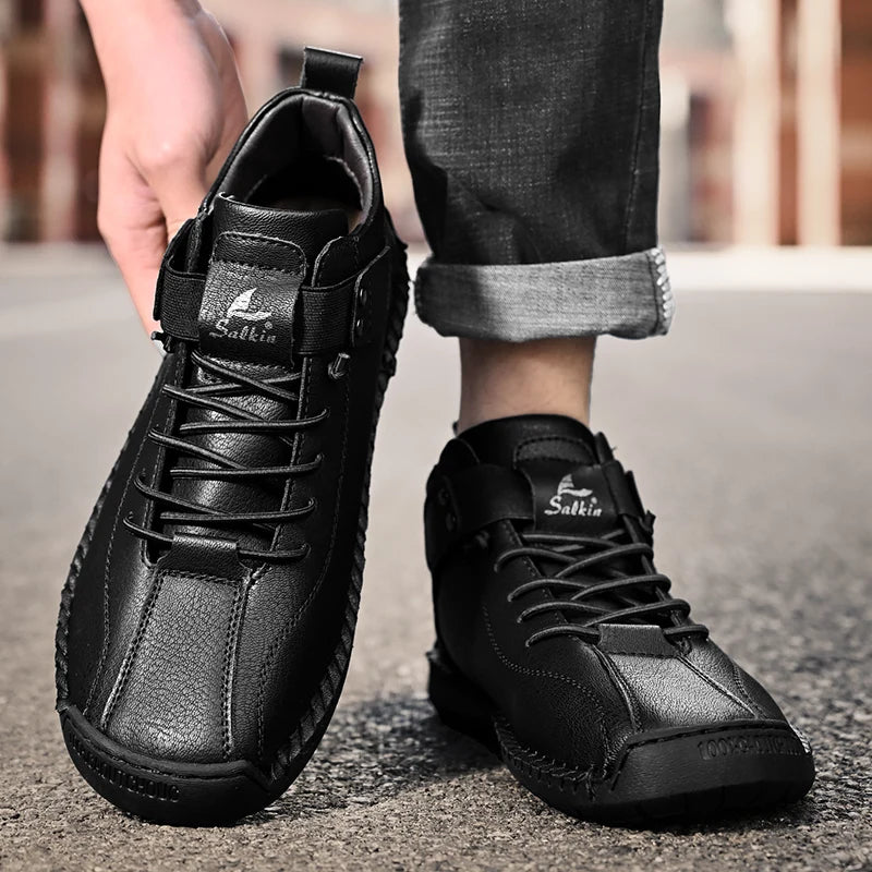 Black leather handmade sneakers with elastic entry, worn casually on street