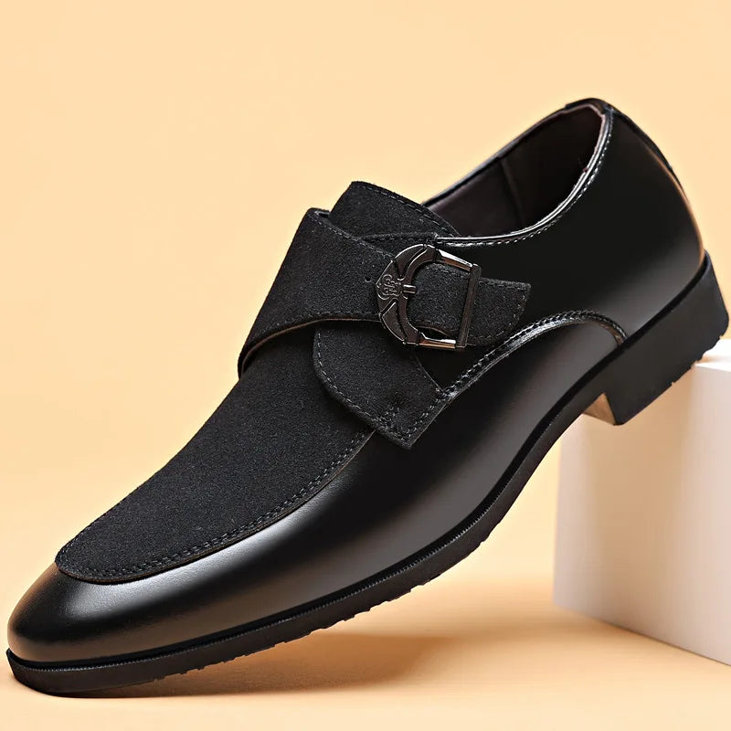 Black men’s leather loafers with pointed toe and metal buckle close-up