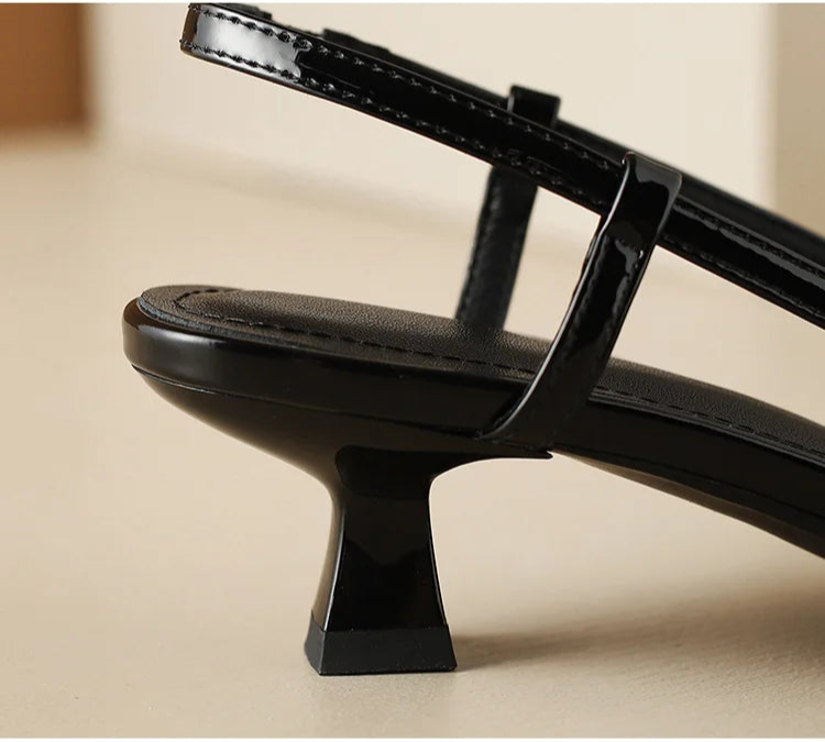 Black slingback heel, close-up of buckle strap