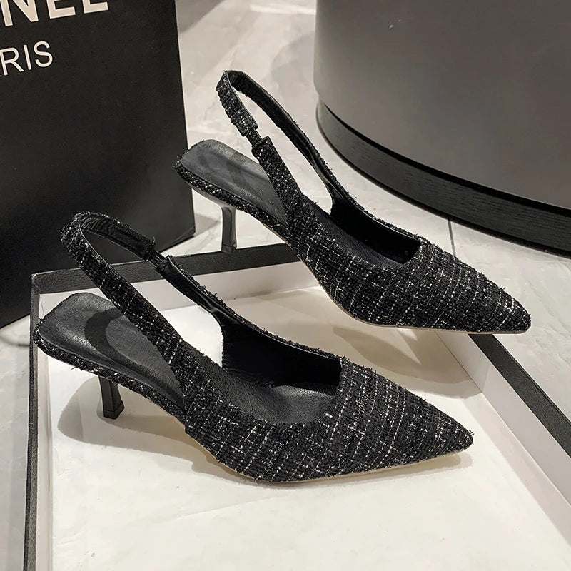 Black tweed slingback heels with pointed toe and open back, side angle