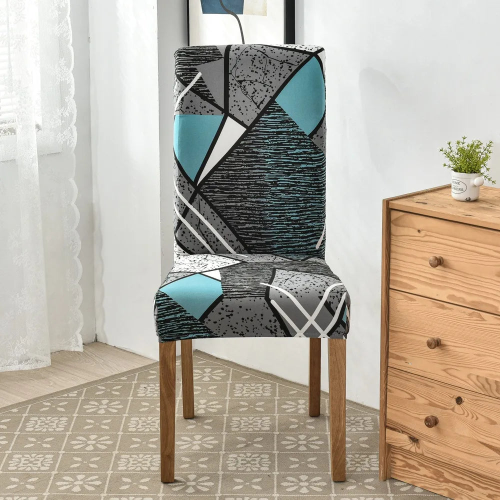 Black, white, and turquoise abstract geometric chair cover on wooden-legged dining chair
