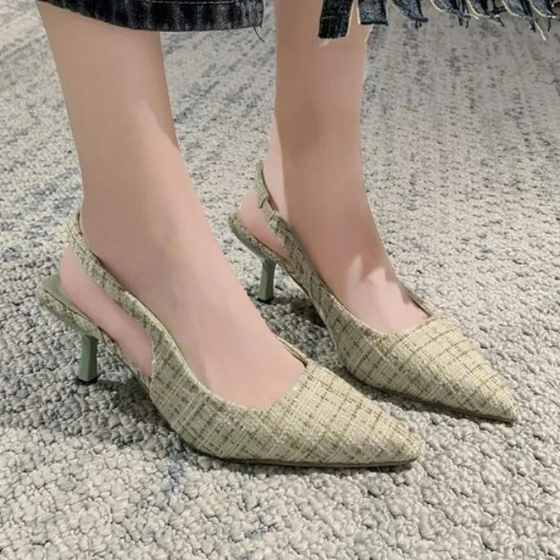 Blue tweed slingback heels worn on foot, indoor setting
