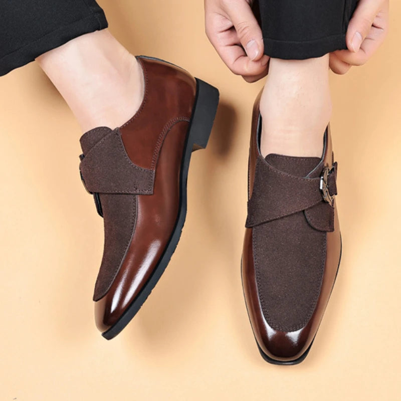 Brown men’s leather loafers worn with black trousers, side angle