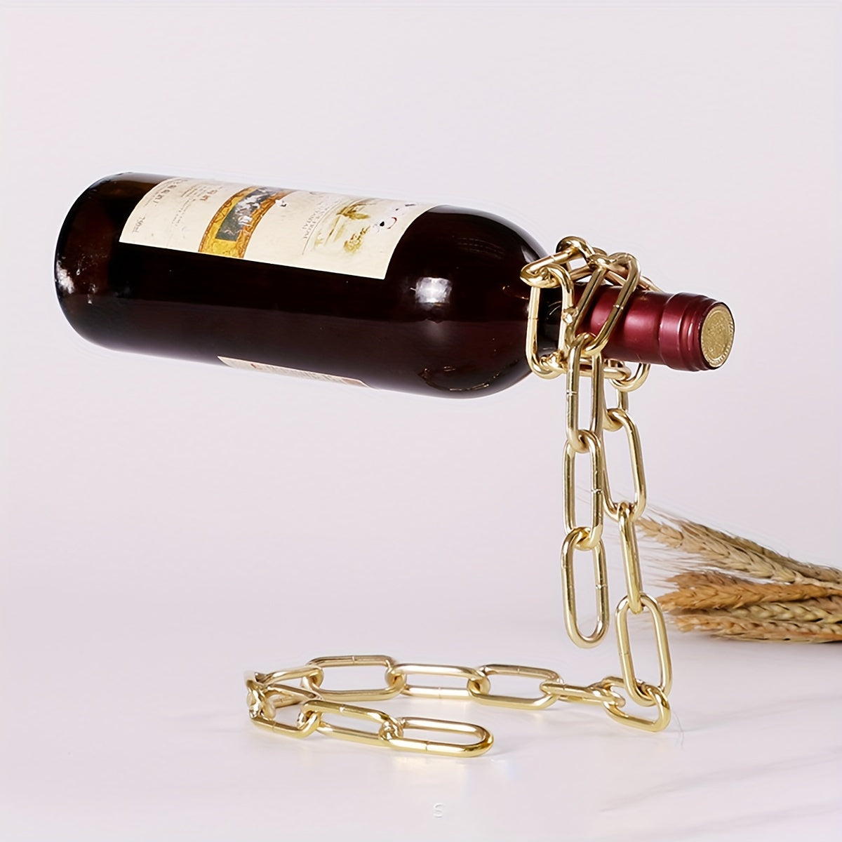 Chrome and gold chain wine holders displayed with bottles on light background