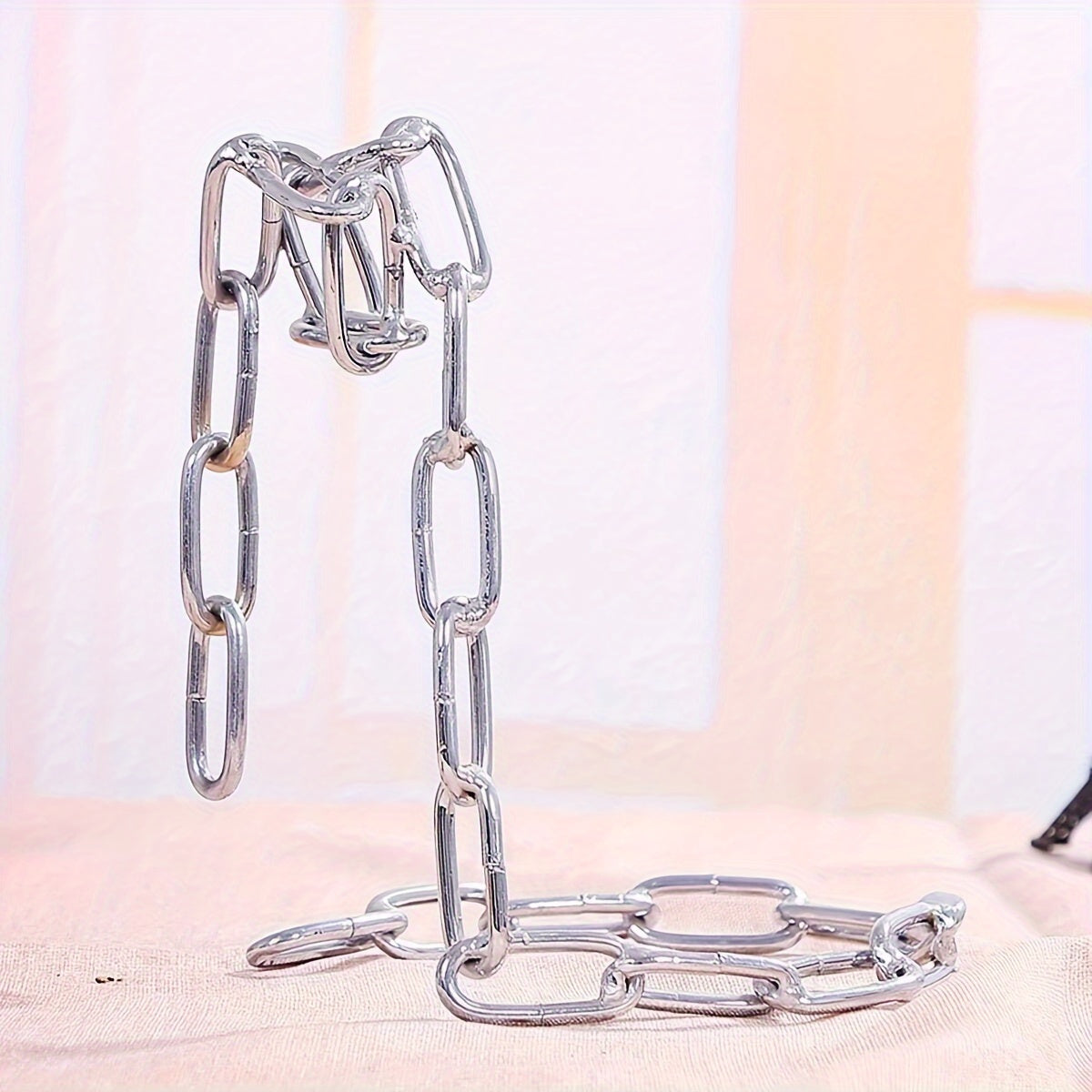 Chrome chain holder upright without bottle, pink fabric background