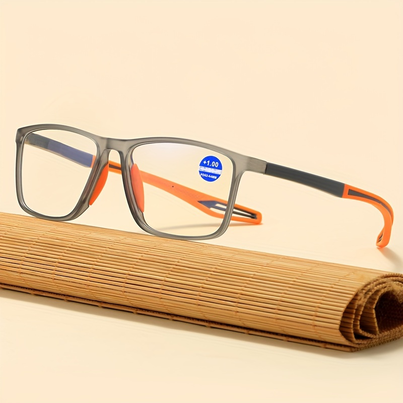 Close-up of TR90 reading glasses with +1.00 lens sticker on beige background
