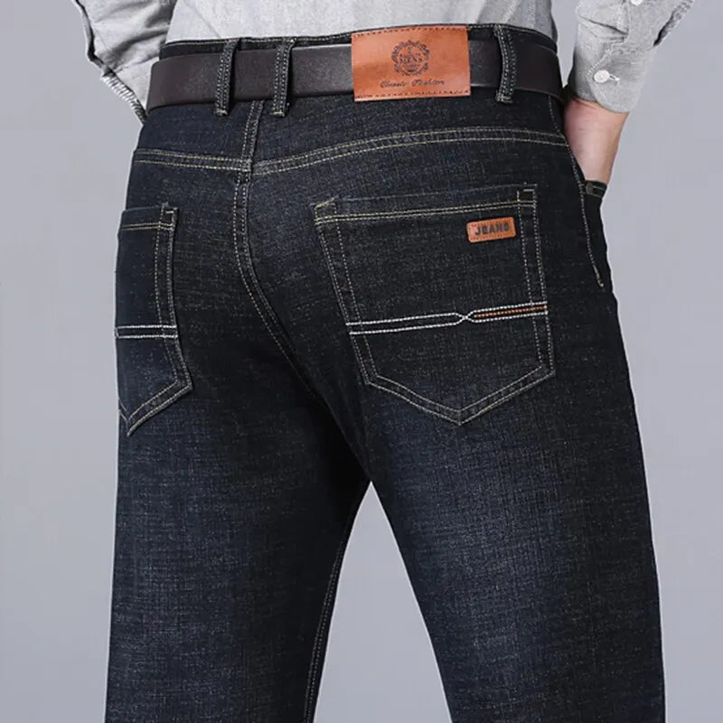 Close-up of back view showing pocket stitching on black stretch denim jeans