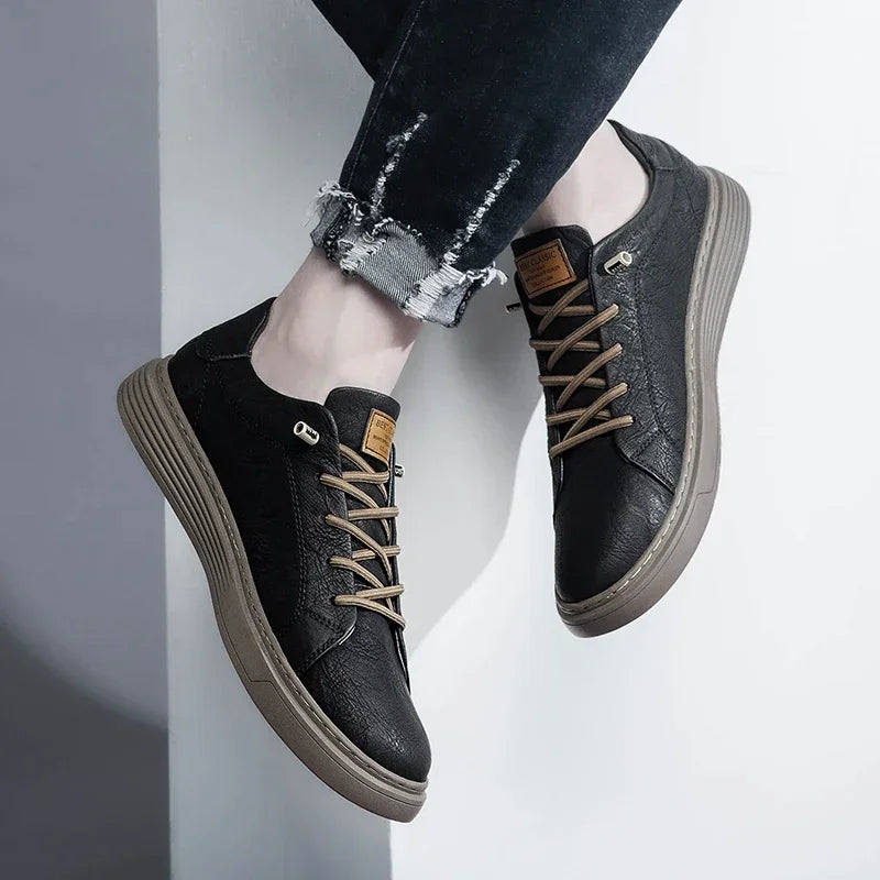 Close-up of black genuine leather sneakers with textured upper and tan laces