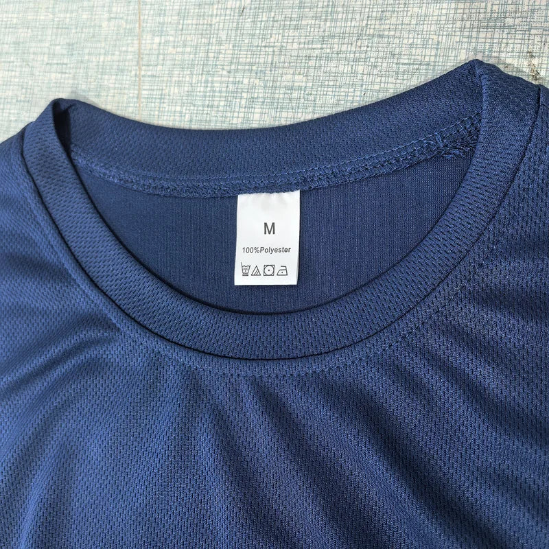 Close-up of blue polyester training shirt neckline with visible size tag