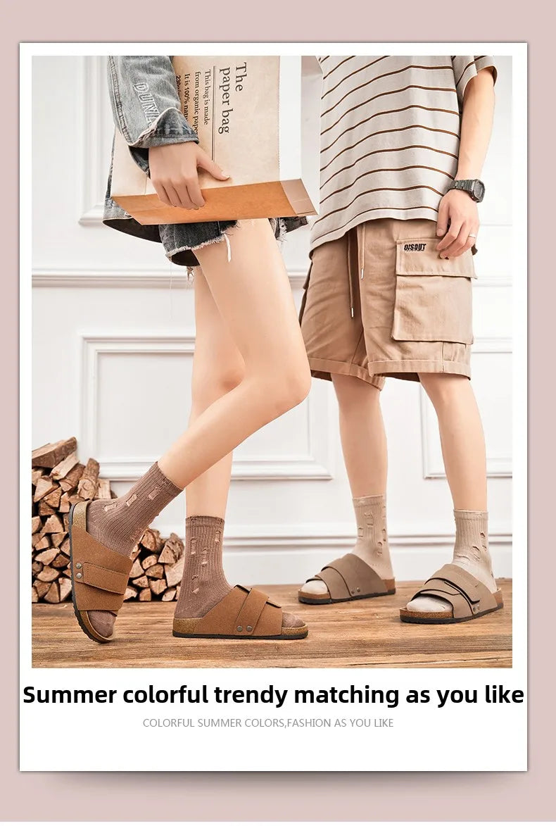 Close-up of brown suede sandals worn with distressed socks, seated on indoor camping chair