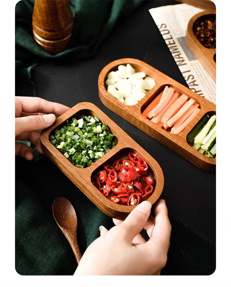 Close-up of condiment trays on black tabletop with green cloth and lemon