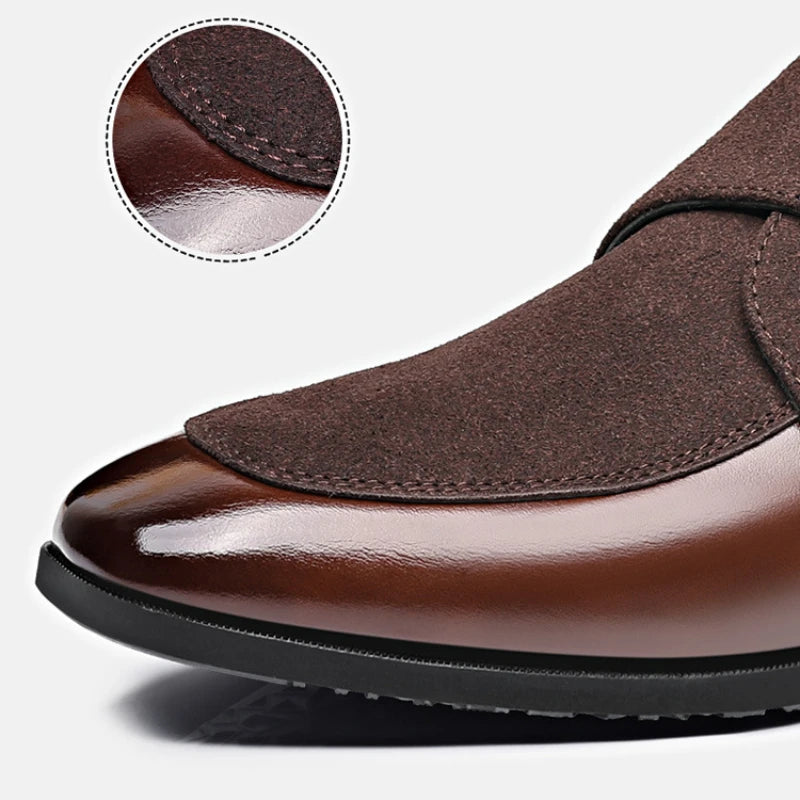 Close-up of metal buckle accent on brown men’s leather loafers
