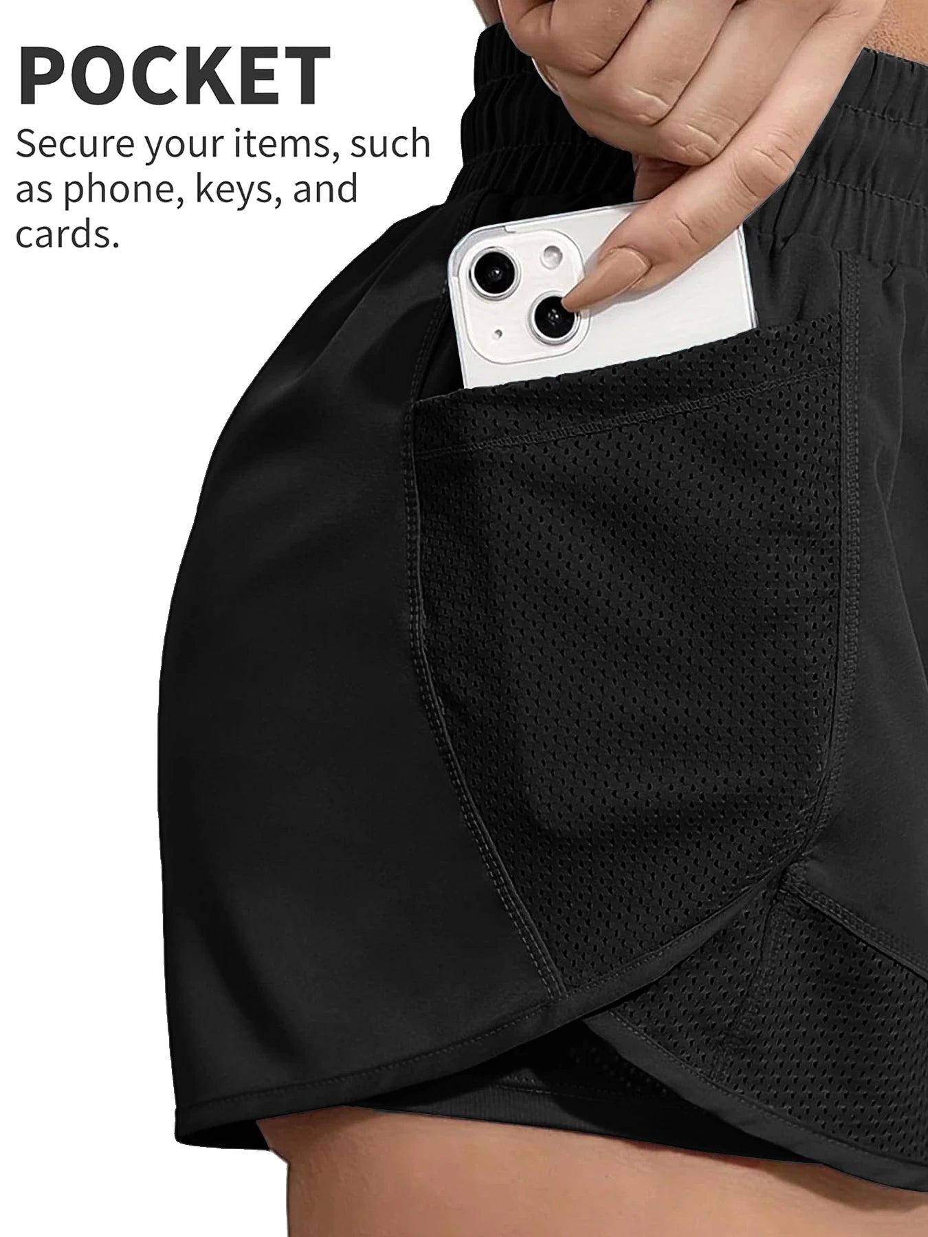 Close-up of phone in mesh pocket on black workout shorts, secure storage feature