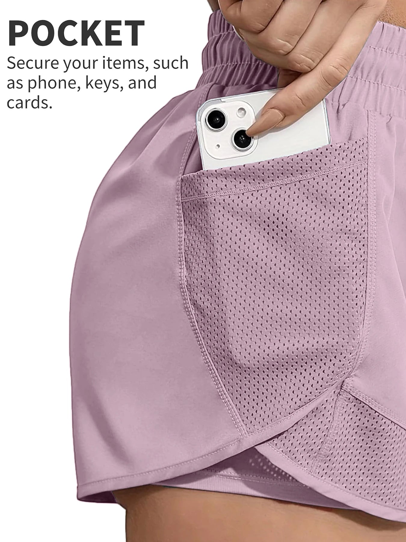 Close-up of phone in mesh pocket on pink workout shorts, secure storage feature