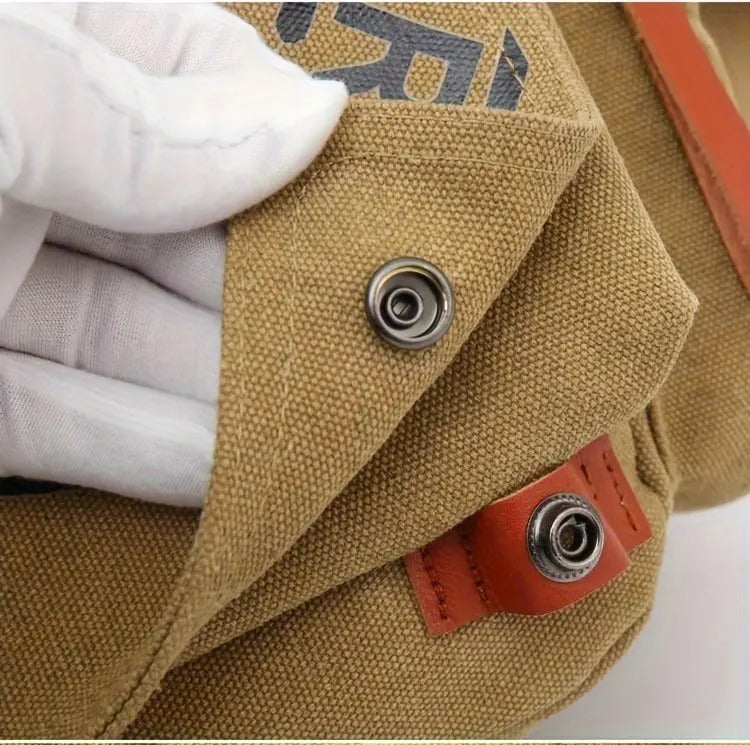 Close-up of snap button closure on Montero Milan canvas sling bag