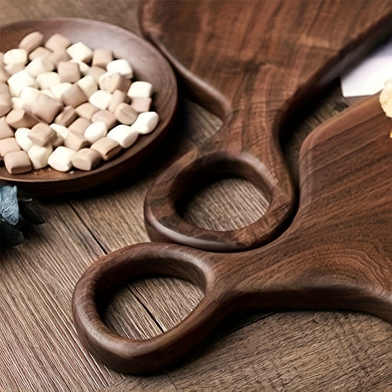 Detail of loop handles on walnut cutting boards with snacks beside