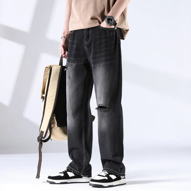Distressed black jeans with backpack prop, shown in casual styling