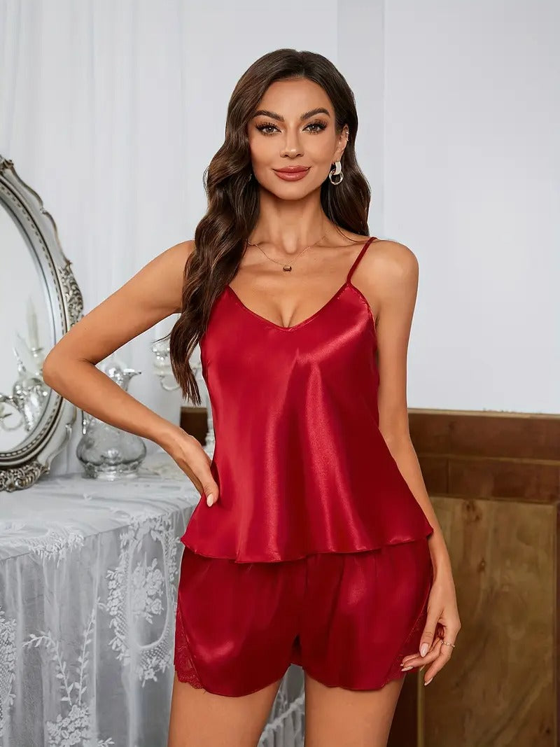 Emerald green satin pajama set with lace accents, standing front view