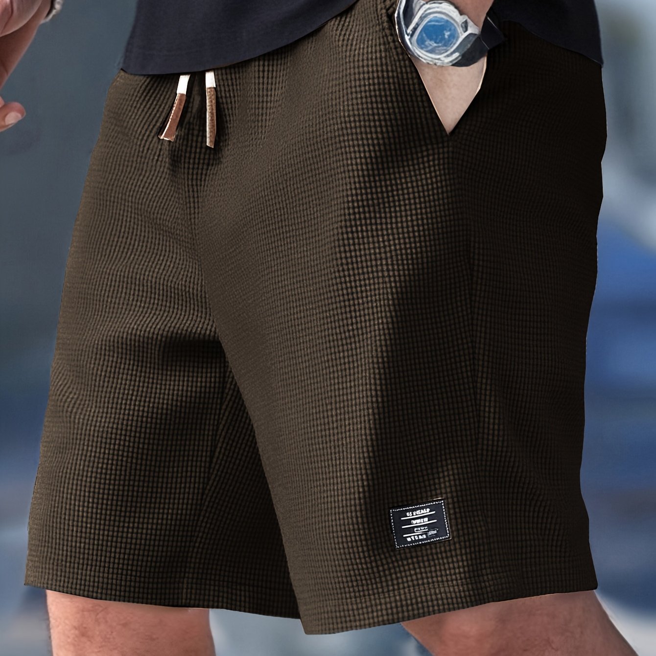 Flat lay of brown textured drawstring casual shorts, angled front view