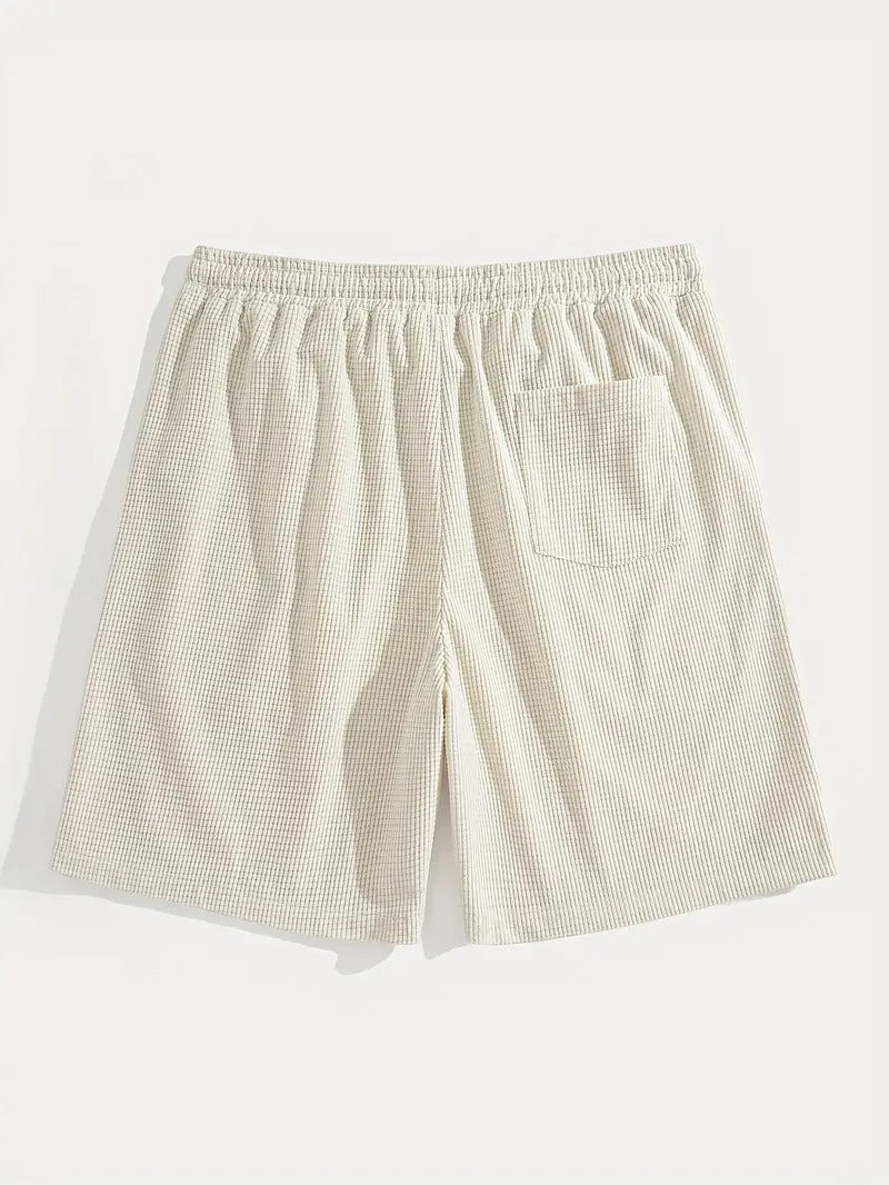 Flat lay of cream textured drawstring casual shorts, close-up of fabric texture