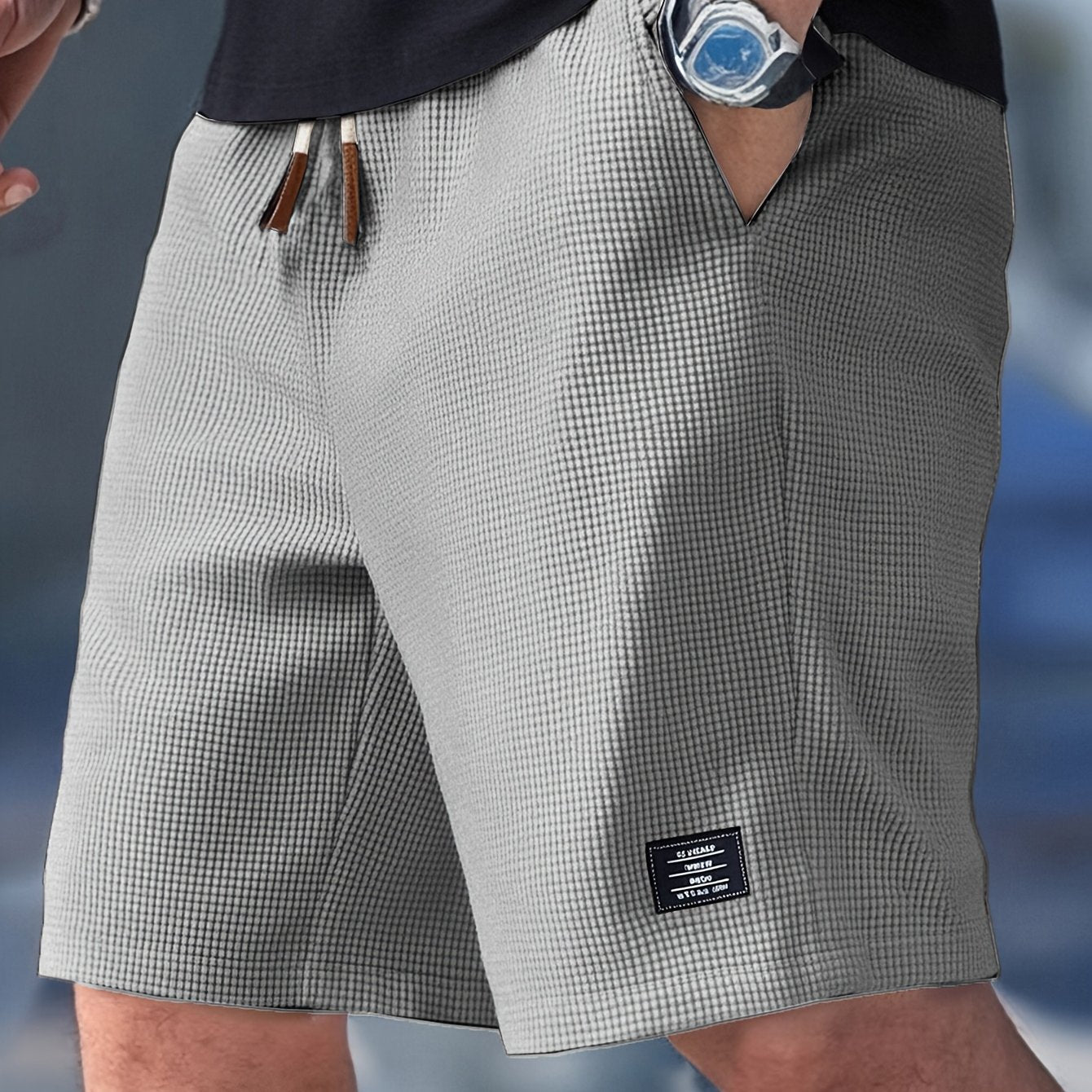 Flat lay of light grey textured drawstring casual shorts, angled front view