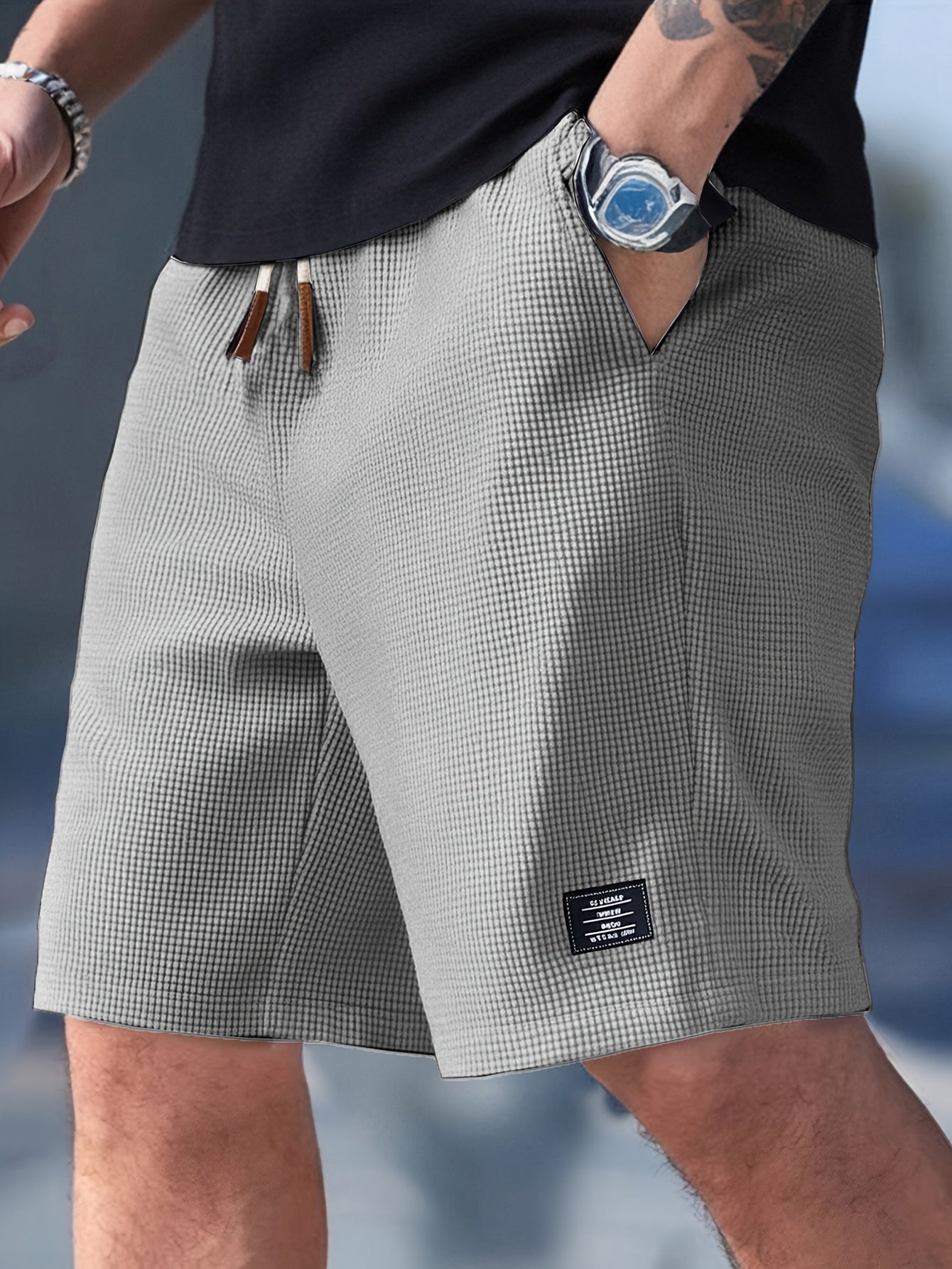 Flat lay of light grey textured drawstring casual shorts, front view