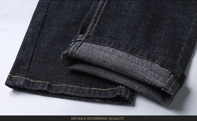 Folded hem detail showing inside fabric texture of black denim jeans