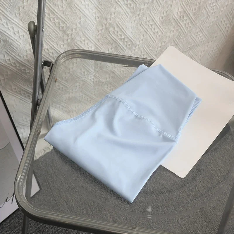 Folded light blue yoga leggings on chair