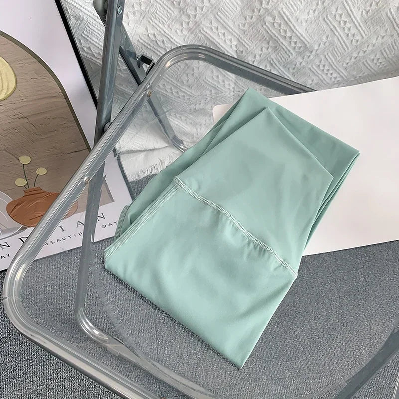 Folded mint green yoga leggings on chair