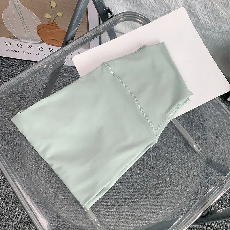 Folded mint green yoga leggings on the chair