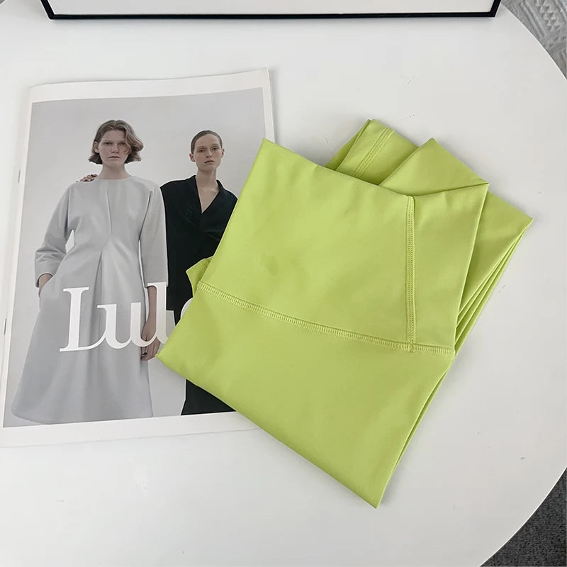 Folded neon green yoga leggings on chair