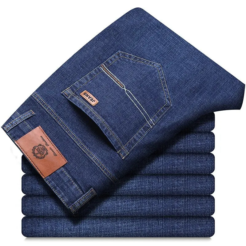 Folded stack of classic men’s straight-leg jeans in medium blue denim, back pocket view