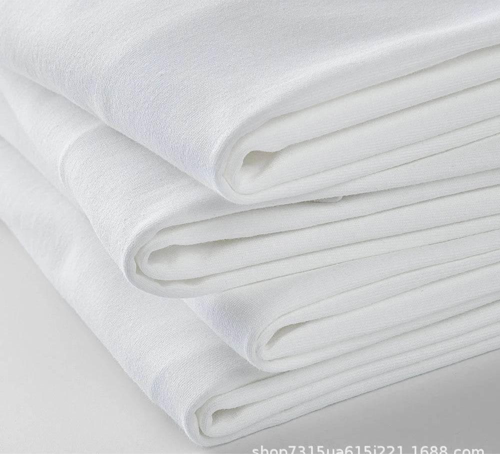 Folded stack of heavyweight combed cotton fabric in white