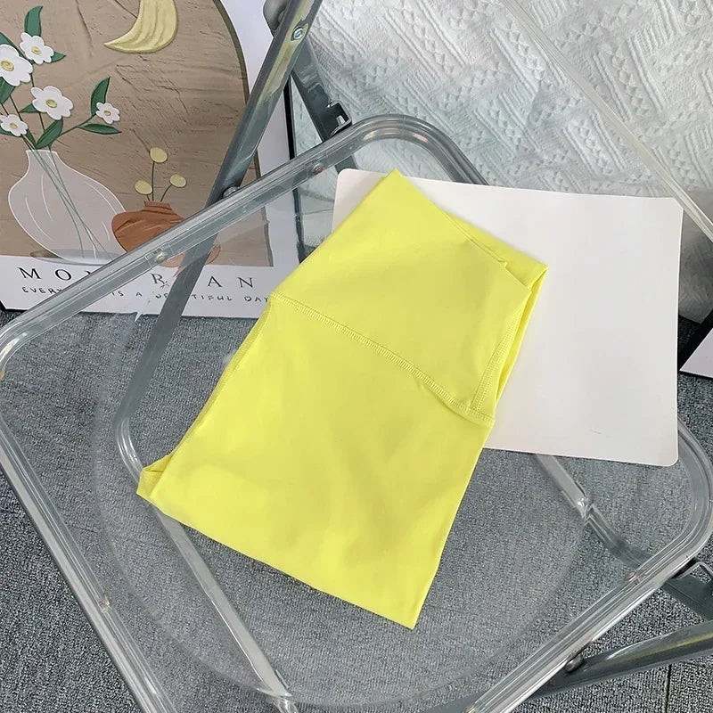 Folded yellow yoga leggings on chair