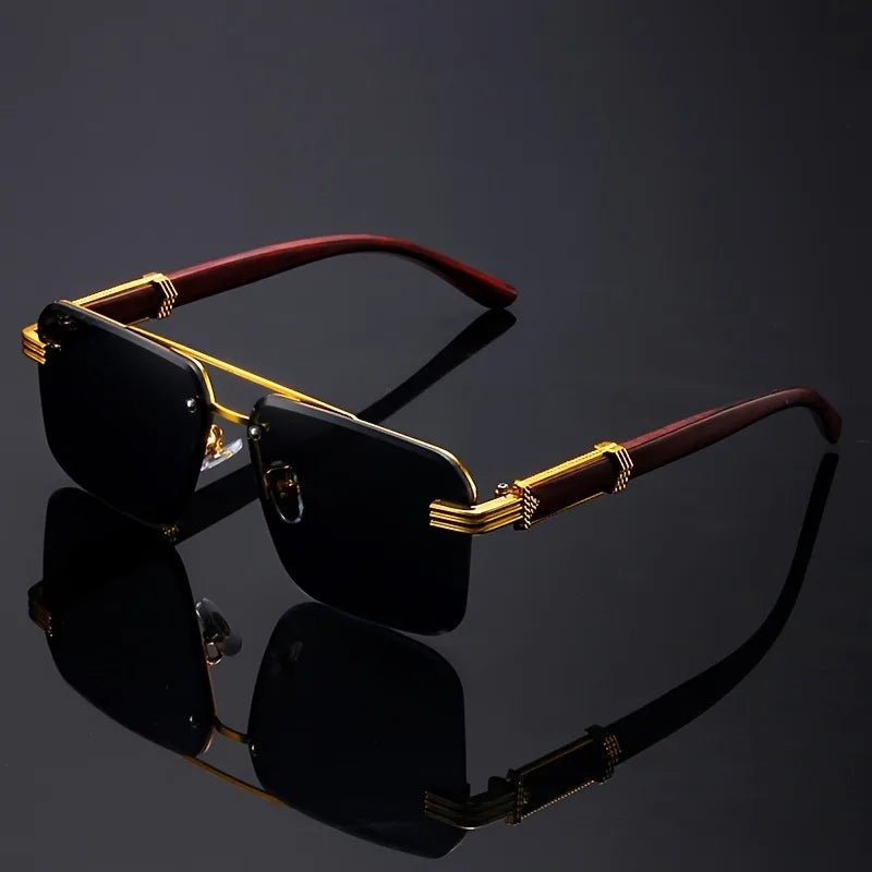 Frameless sunglasses with blue gradient lenses and gold temples on black reflective background