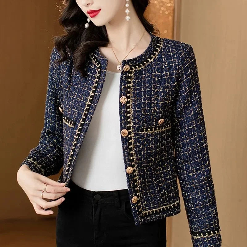 Front angled pose of women’s navy tweed jacket with chain trim
