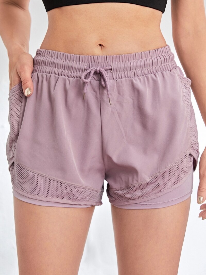 Front view of lavender athletic shorts with drawstring waist and dual mesh side pockets