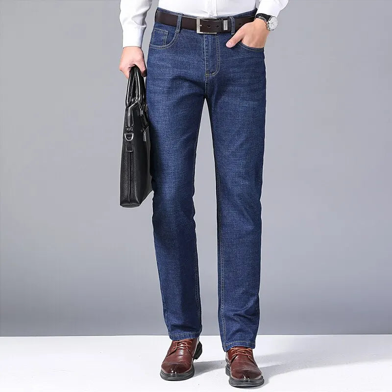 Full front view of model in medium wash jeans styled with formal shirt and briefcase
