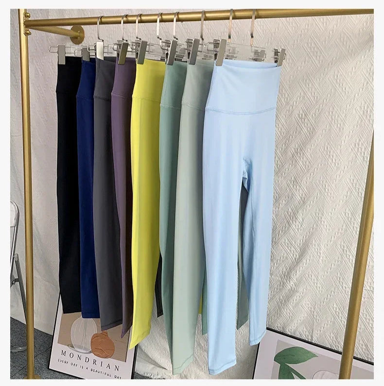 Full set of yoga leggings in multiple colors displayed on rack