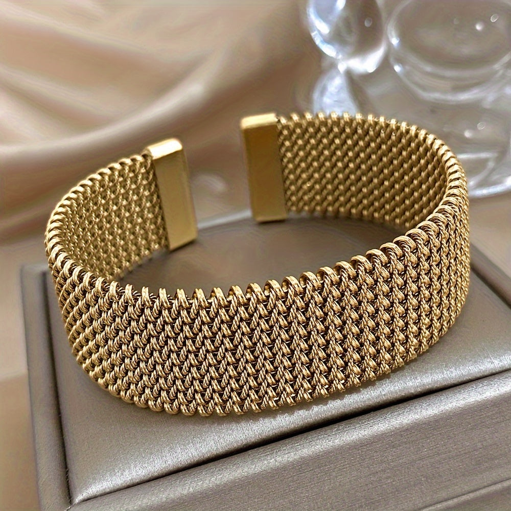 Gold stainless steel bracelet on display box, straight view