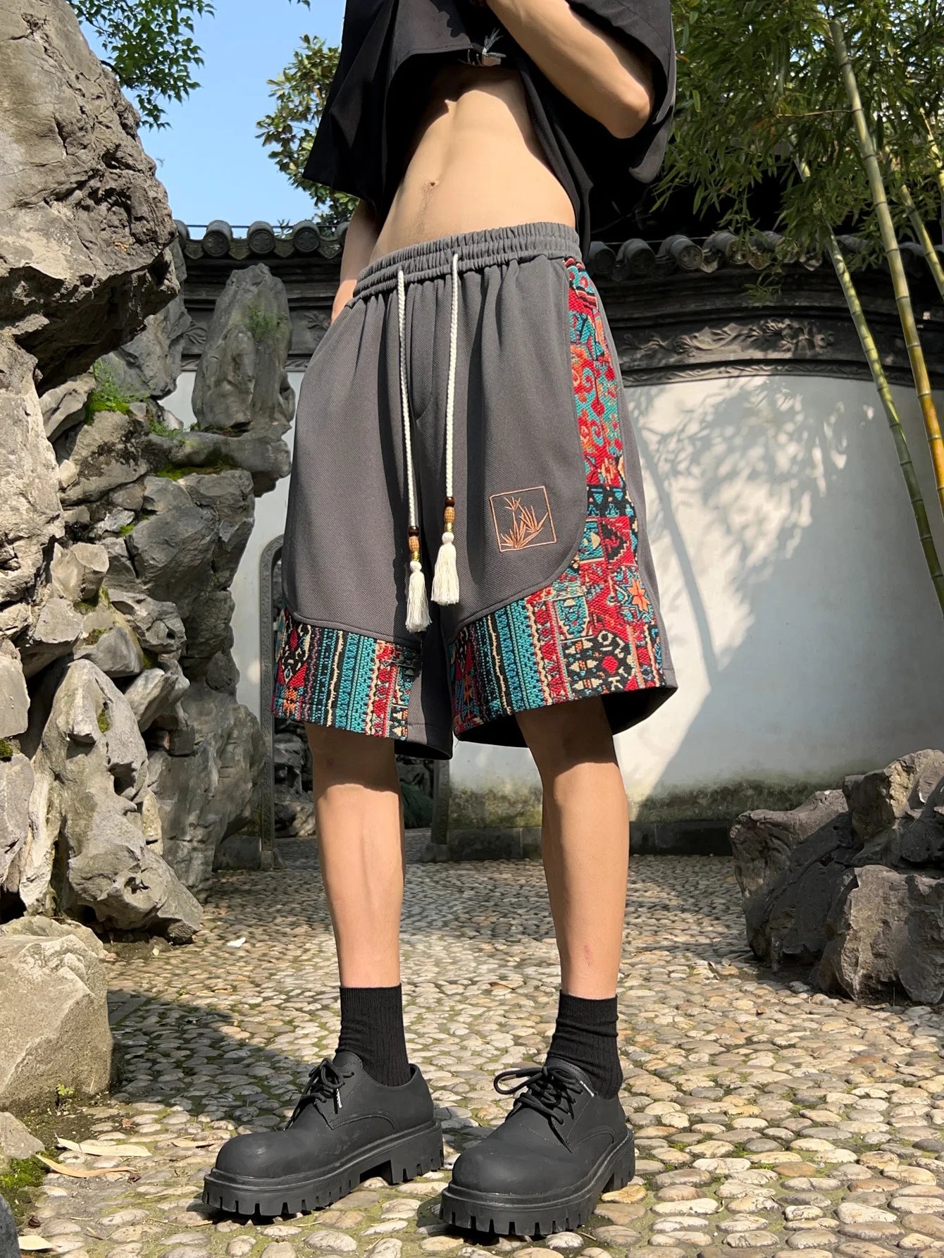 Gray shorts with front view showcasing ethnic embroidery and tassel cords