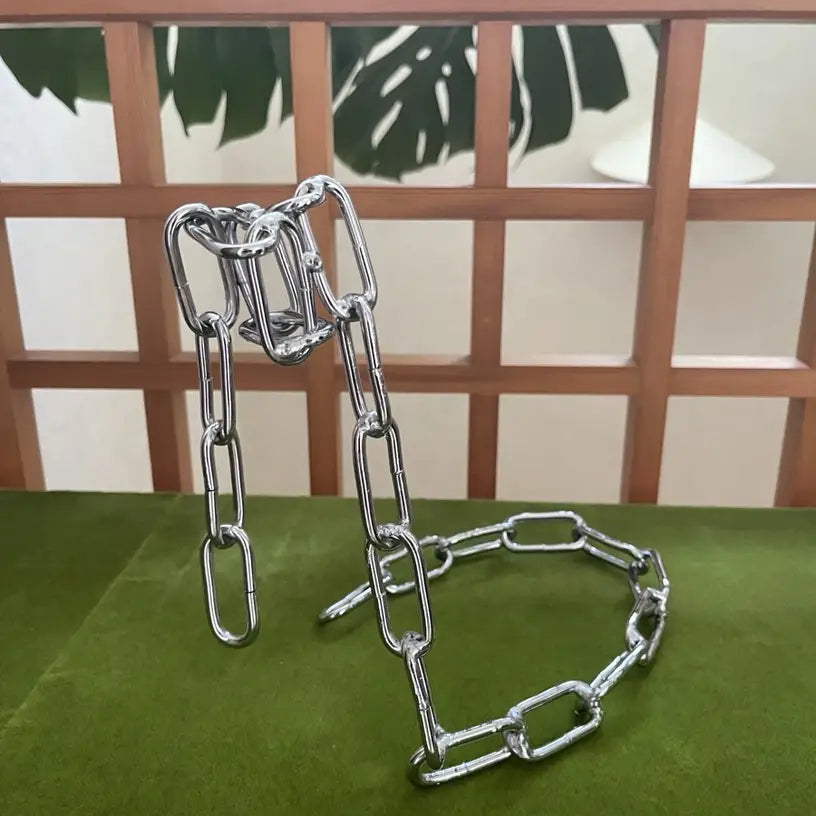 Green-painted chain wine holder displayed on artificial grass background